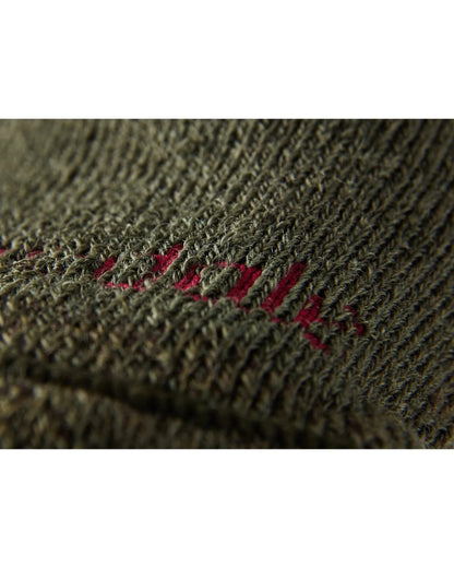 Close up of Olive coloured Bridgedale Heavyweight Merino Performance Socks on a white background 