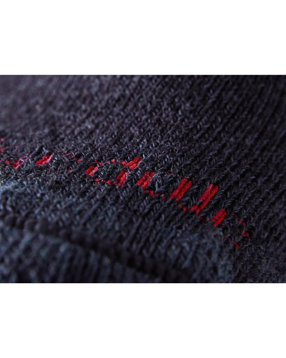 Close up of Navy coloured Bridgedale Heavyweight Merino Performance Socks on a white background 