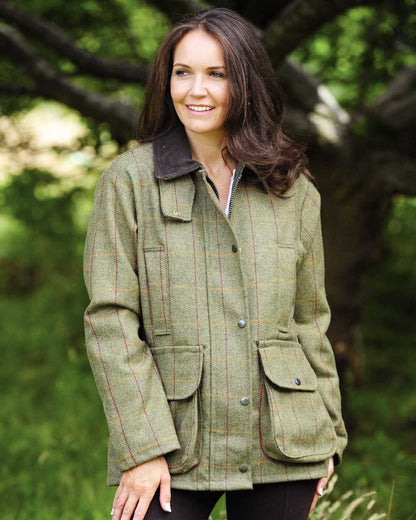 Dark Green coloured Bronte Ladies Crompton Tweed Field Coat on tree background 