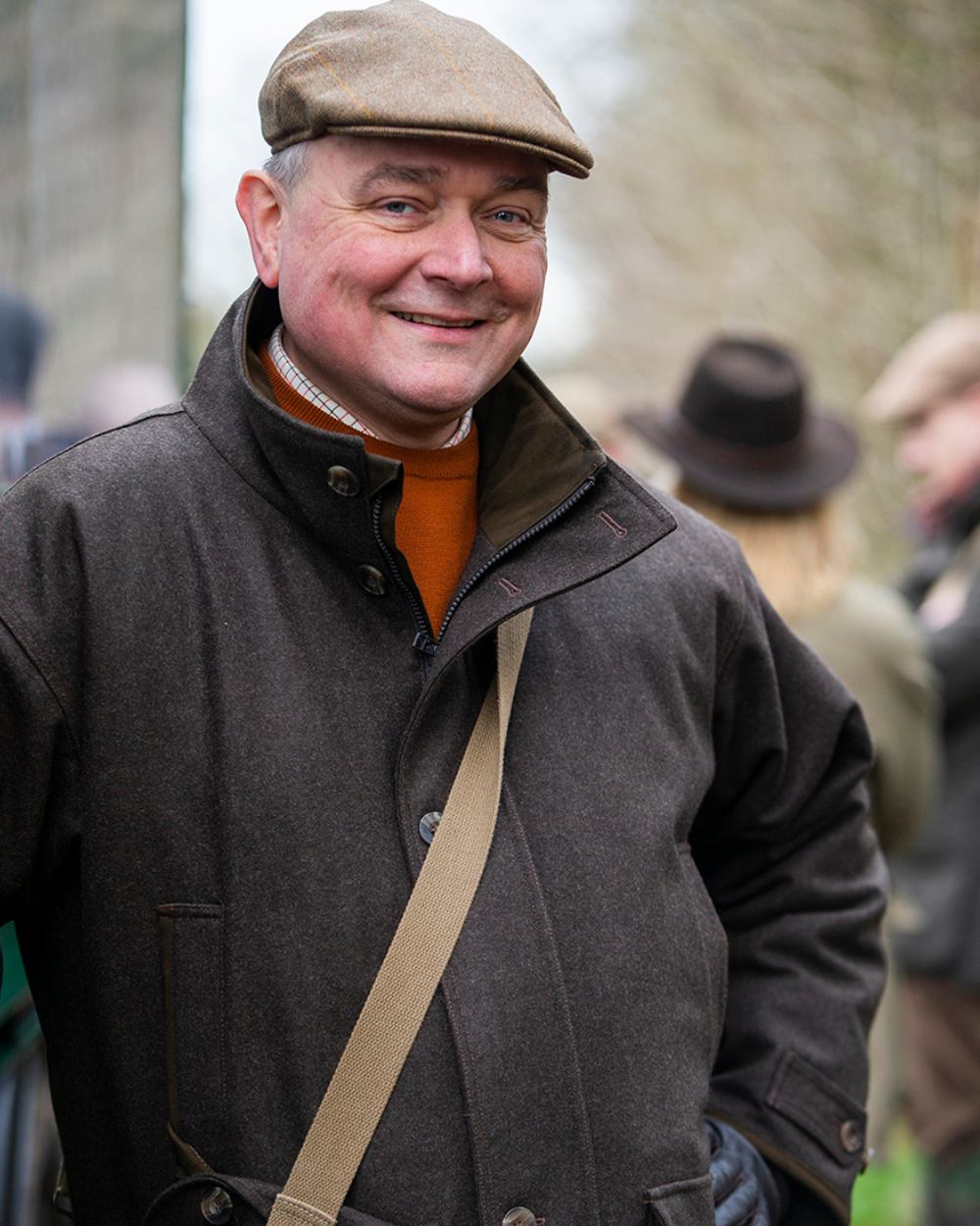 Brown Coloured Laksen Matterhorn Wingfield Loden Coat With CTX On A rural Background