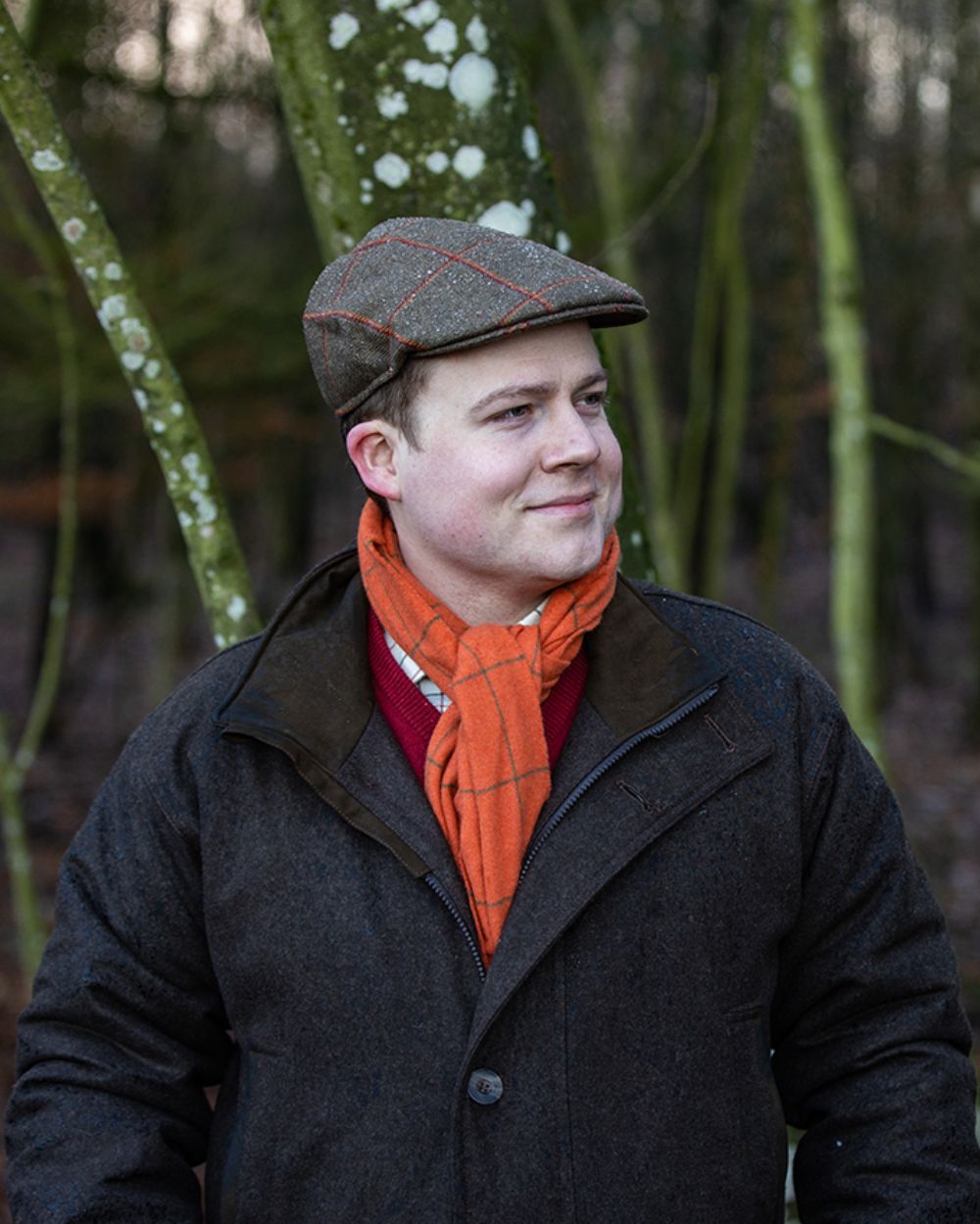 Brown Coloured Laksen Matterhorn Wingfield Loden Coat With CTX On A woodland Background