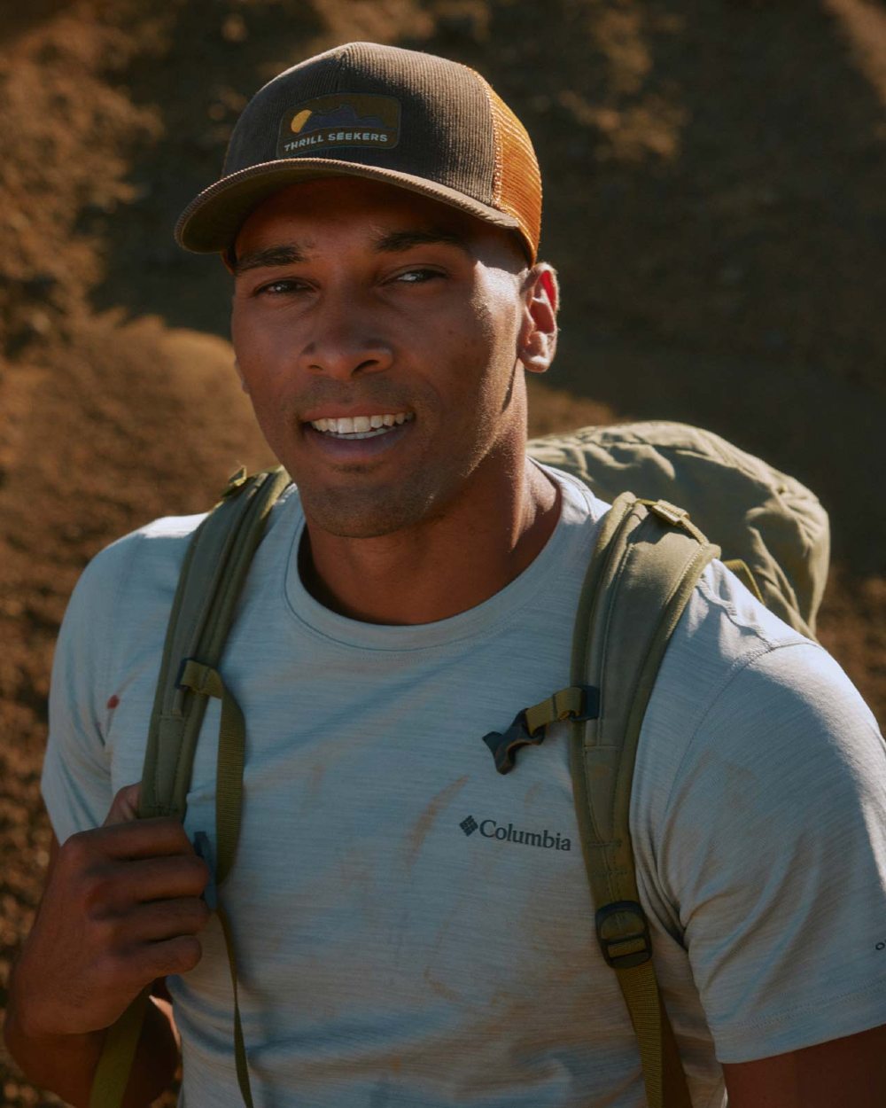 Brown Coloured Buff Explore Trucker Cap on ground background 