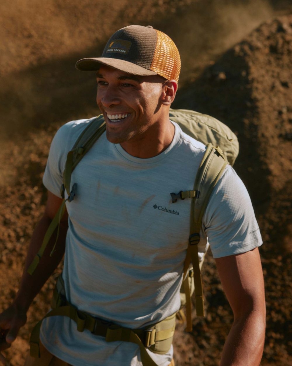 Brown Coloured Buff Explore Trucker Cap on ground background 