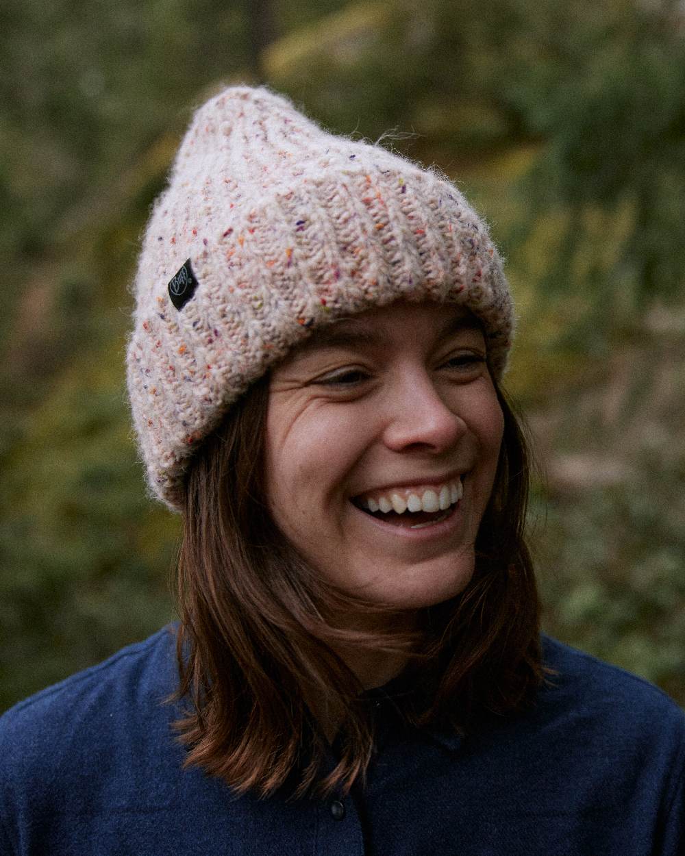 White Coloured Buff Kim Knitted Fleece Beanie on blurry background 