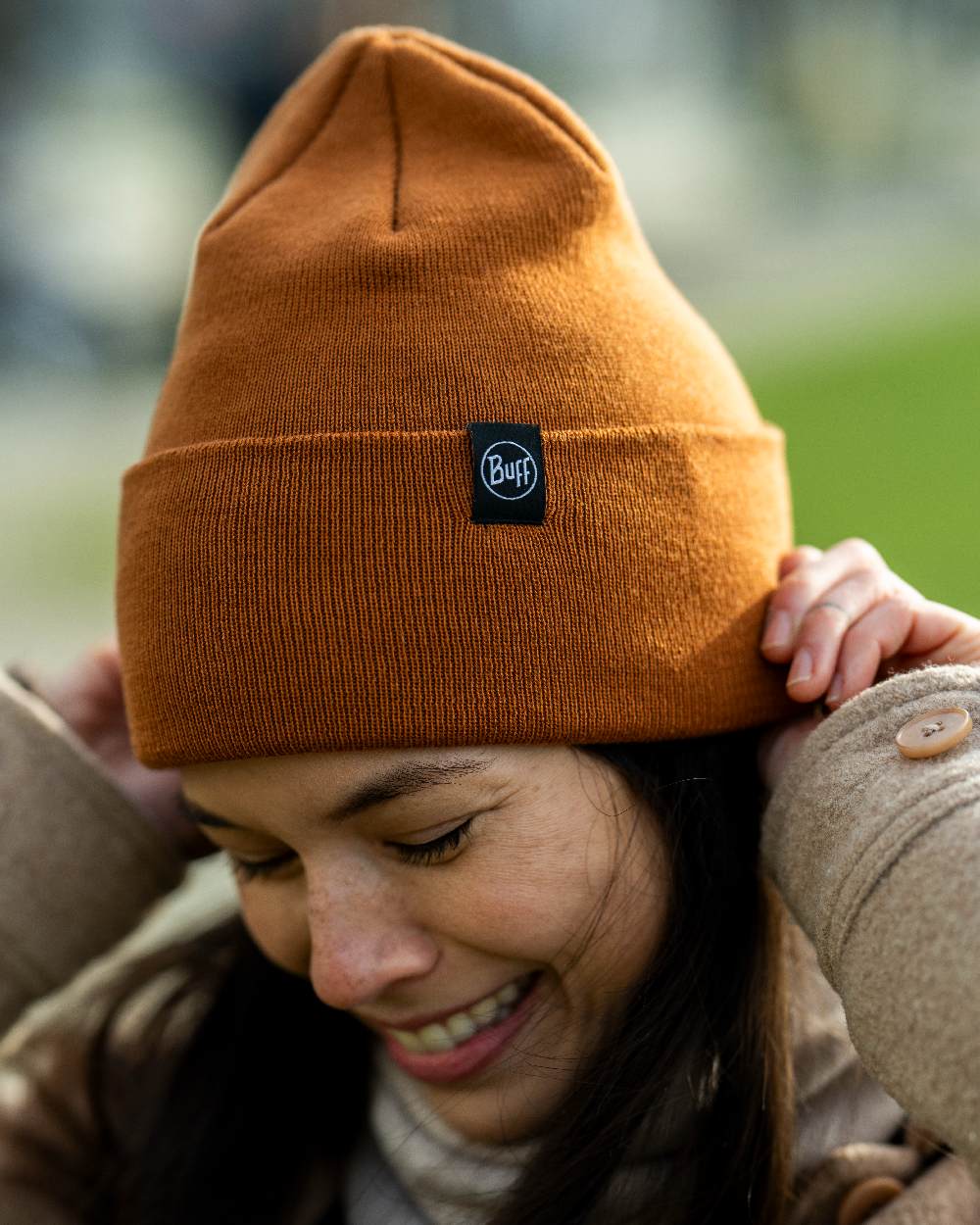 Copper Coloured Buff Linon Knitted Beanie on blurry background 