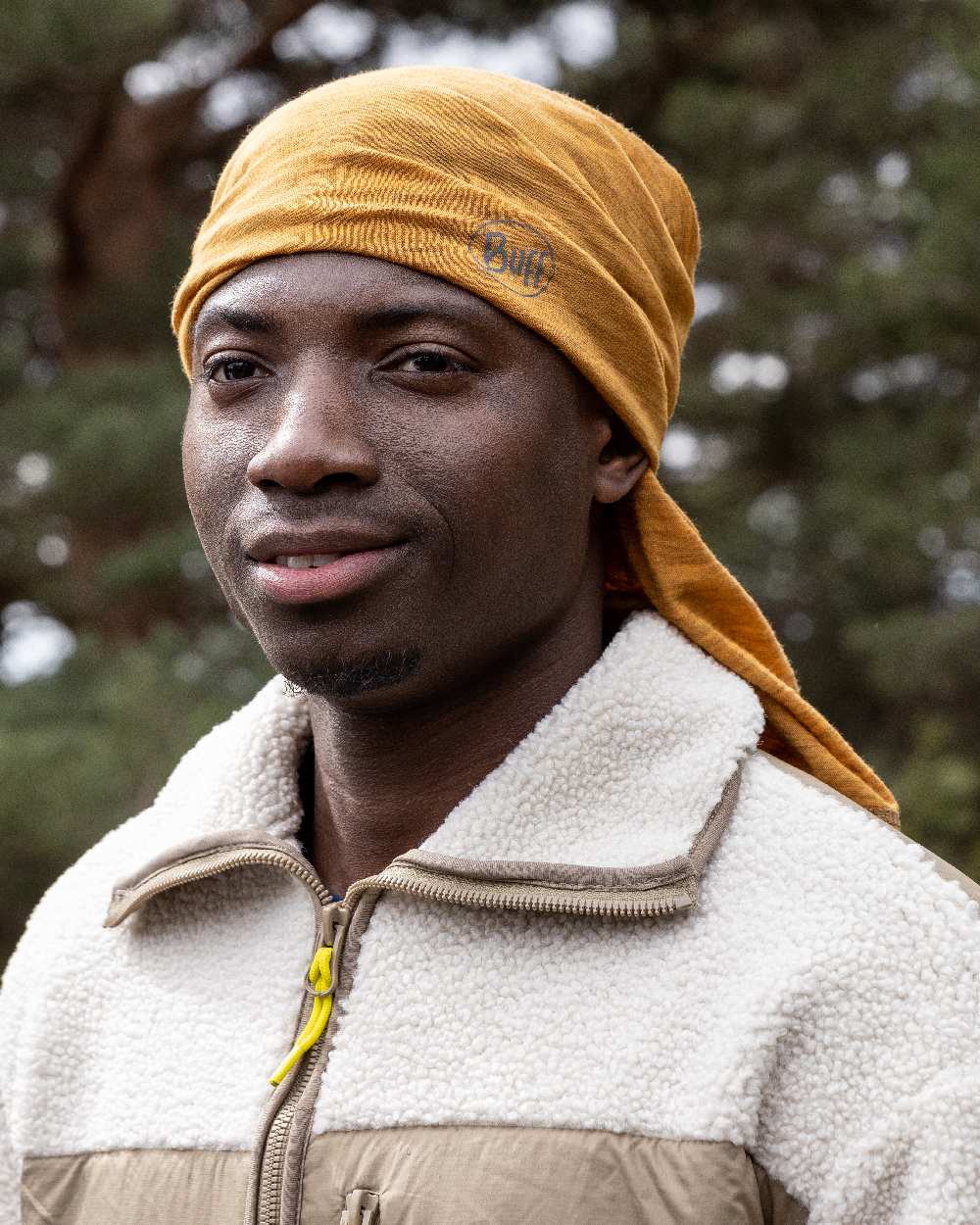 Mustard Coloured Buff Merino Lightweight Neck Warmer on outdoor background 