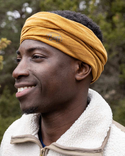 Mustard Coloured Buff Merino Lightweight Neck Warmer on outdoor background 