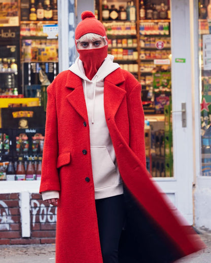 Orange Red Coloured Buff Nilan Knitted Balaclava on shops background 