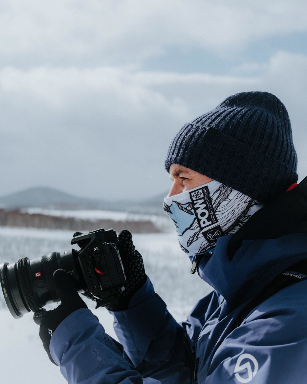 Midnight Coloured Buff Rutger Knitted Beanie on snow background 