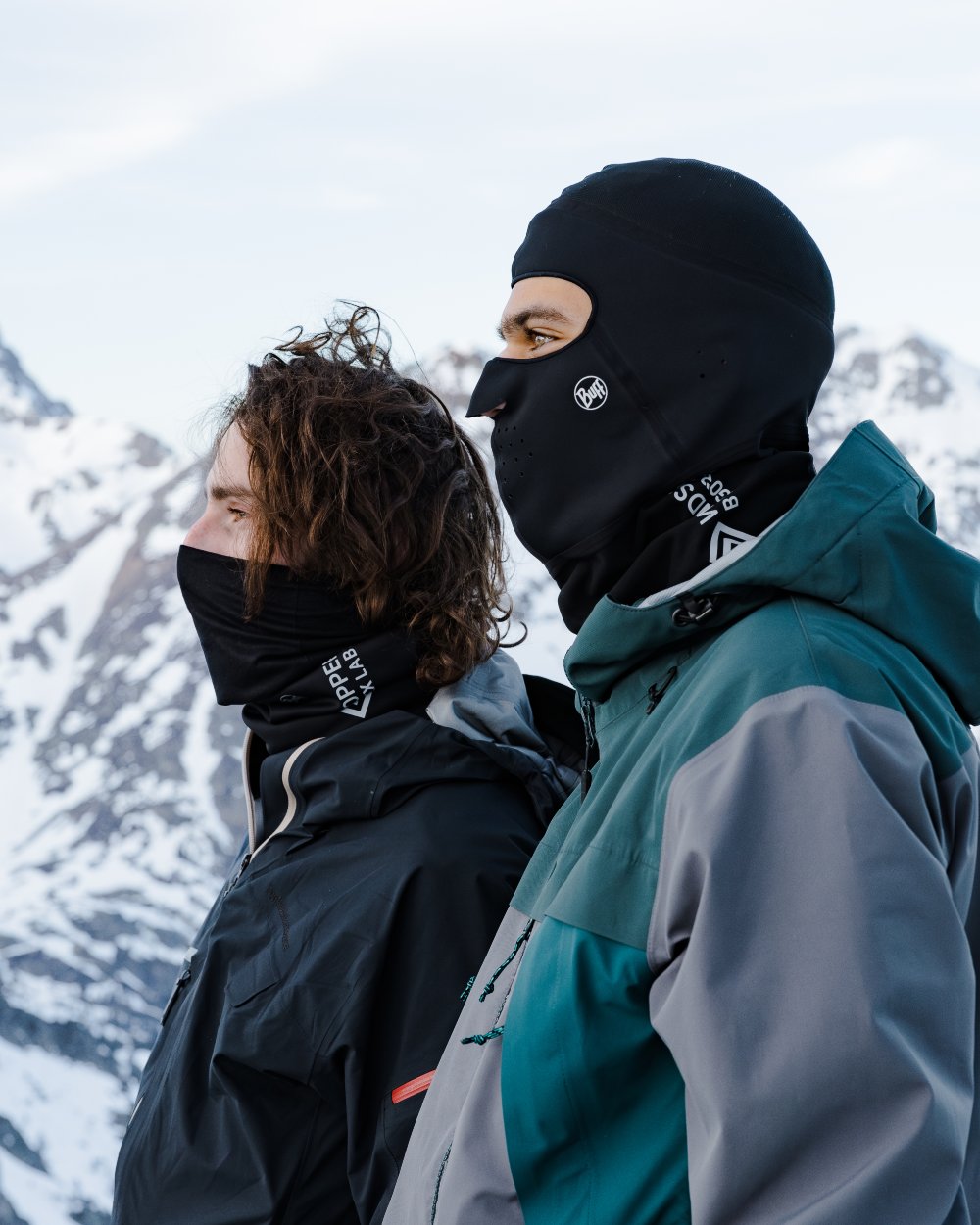 Black Coloured Buff Windproof Solid Balaclava on snow background 