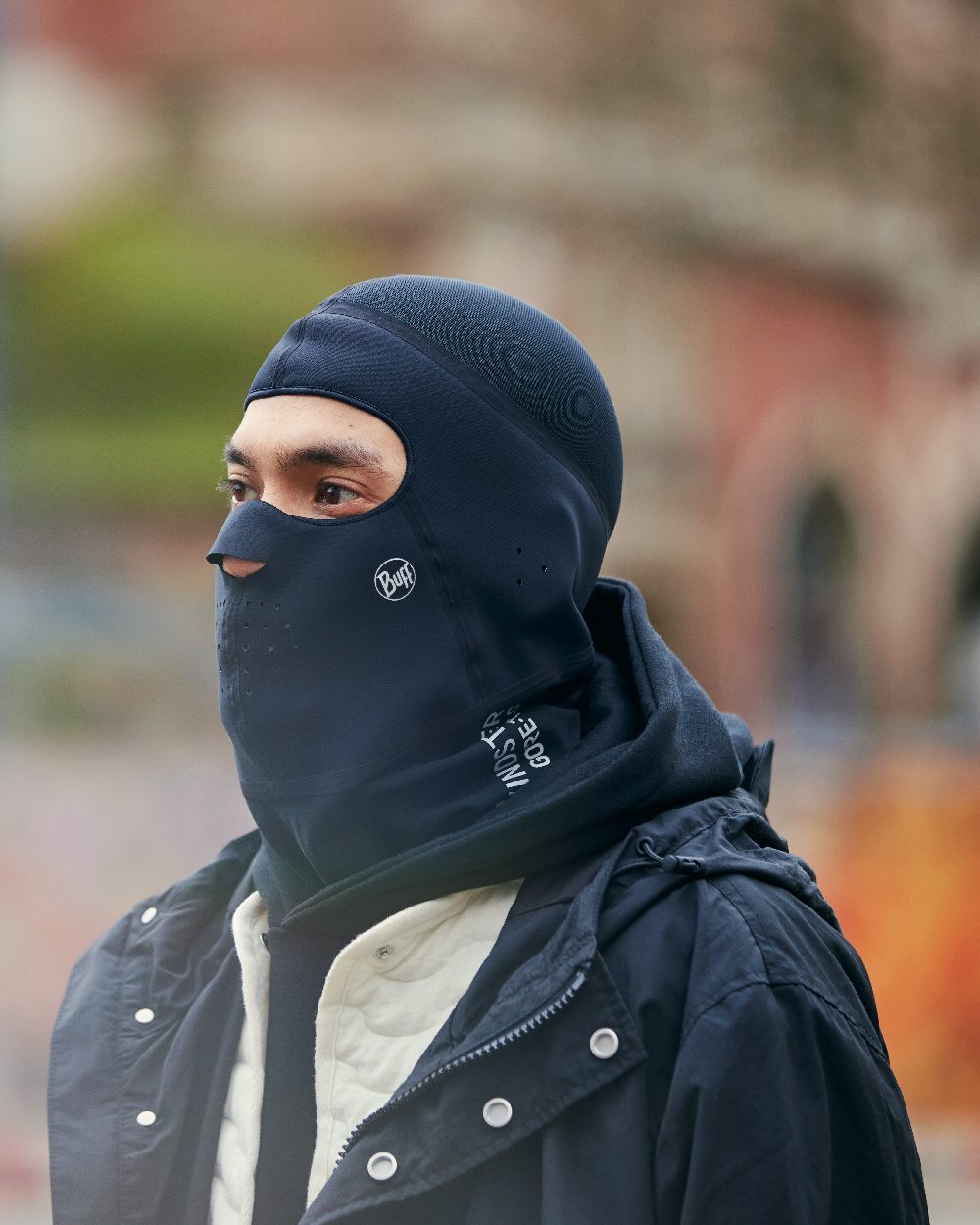 Black Coloured Buff Windproof Solid Balaclava on blurry background 