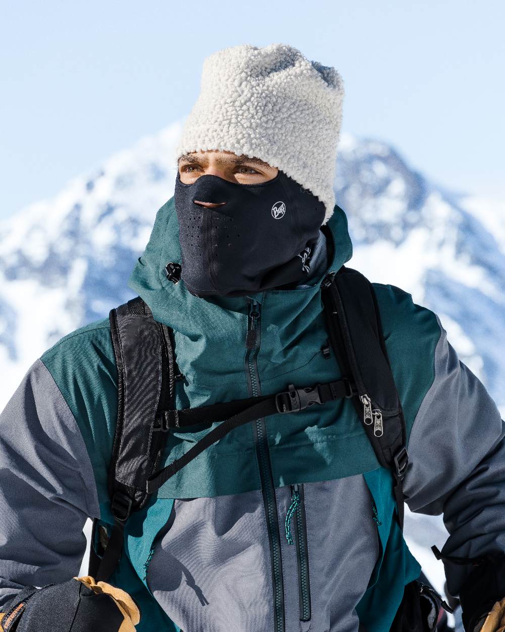 Black Coloured Buff Windproof Solid Balaclava on snow background 