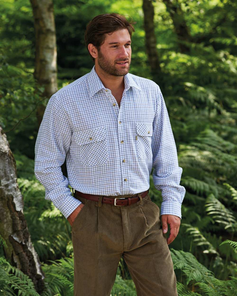Blue coloured Champion 100% Cotton Tattersall Check Shirt on forest background 