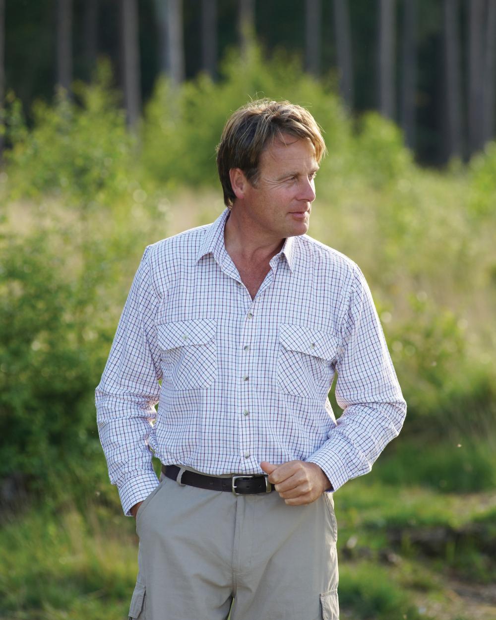 Red coloured Champion 100% Cotton Tattersall Check Shirt on forest background 