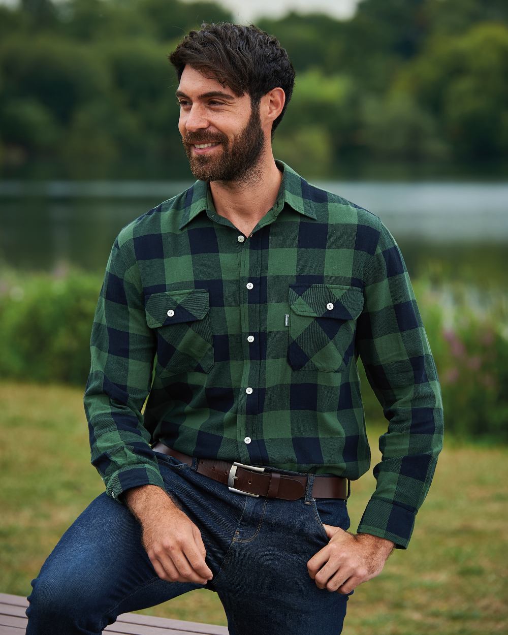 Green coloured Champion Arran Long Sleeve Shirt on pond background 