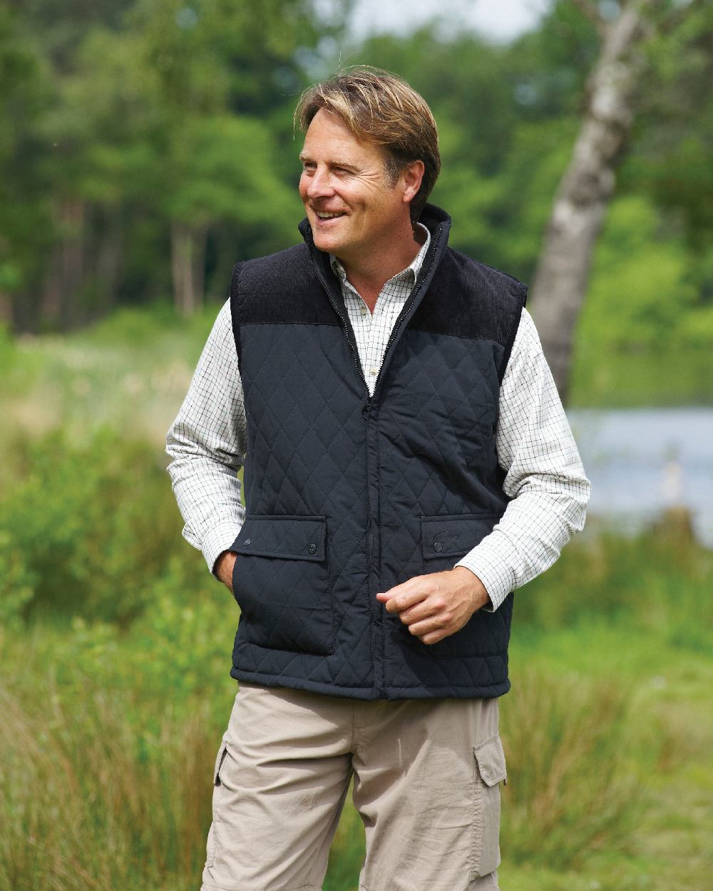 Black coloured Champion Arundel Diamond Quilted Bodywarmer on forest background 