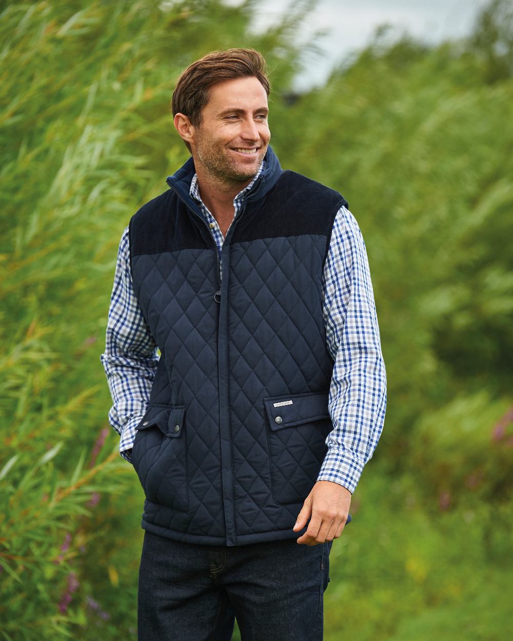 Navy coloured Champion Arundel Diamond Quilted Bodywarmer on backyard background 