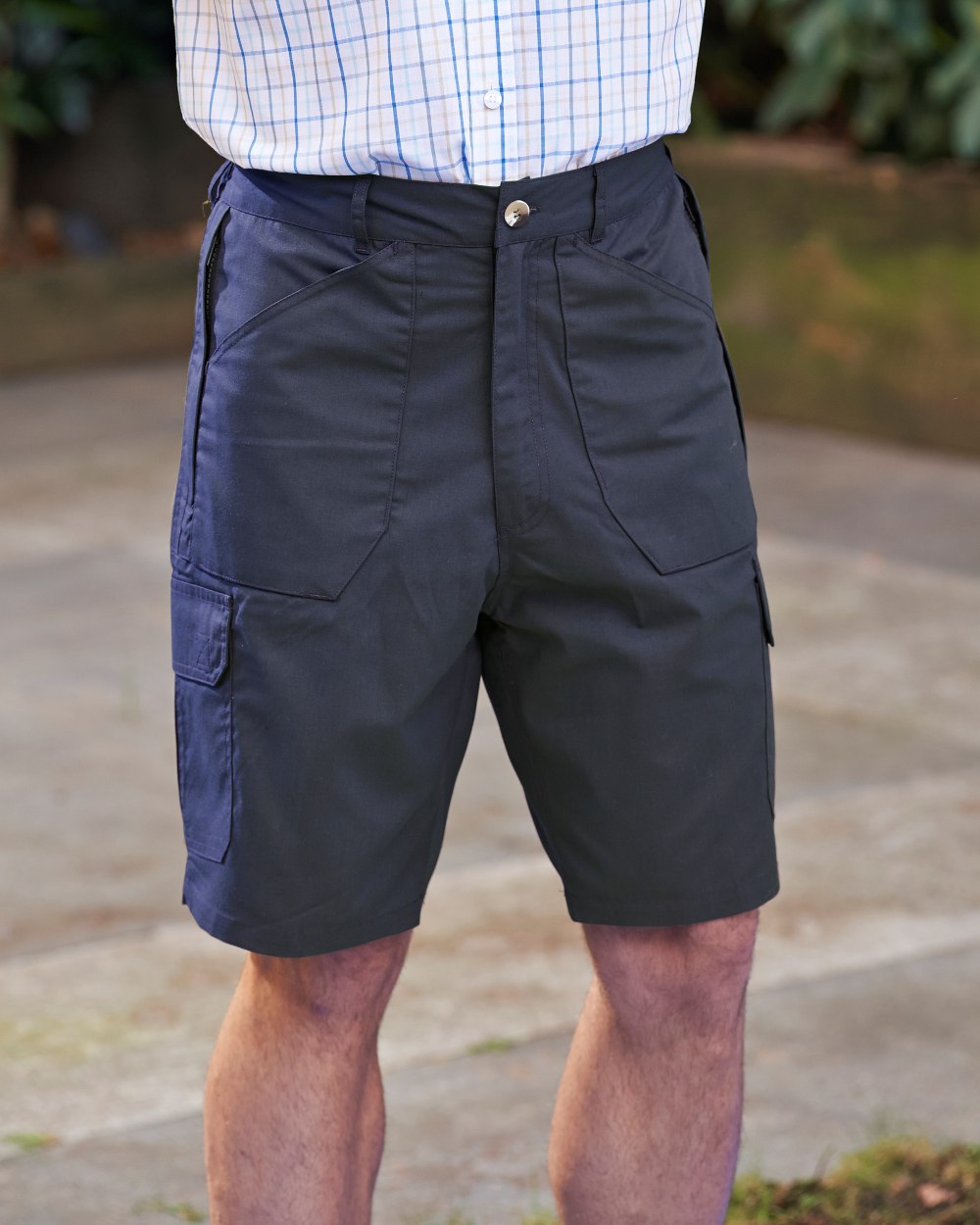 Navy coloured Champion Bretton Multi-Pocket Activity Shorts on backyard background 
