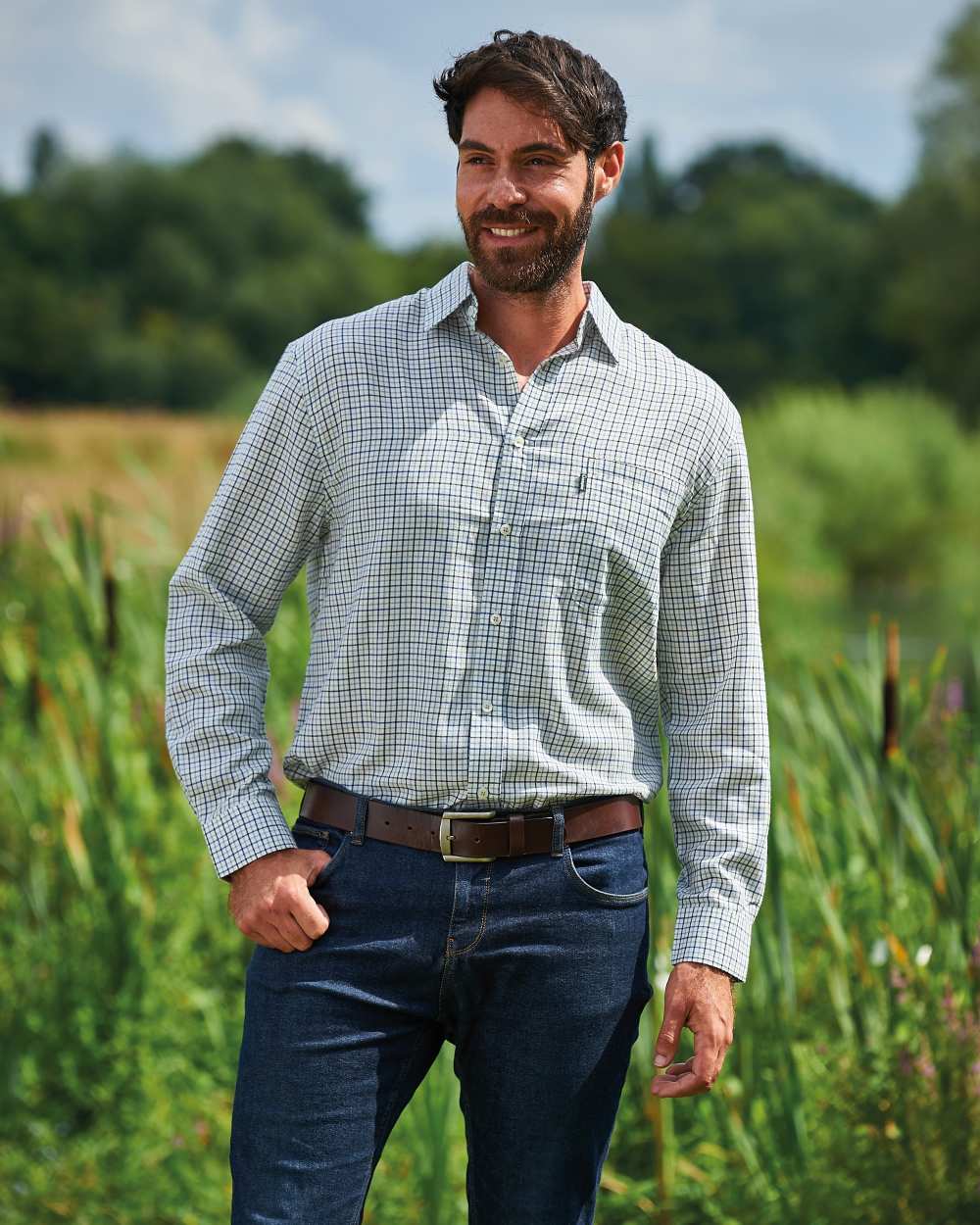Blue coloured Champion Epsom Long Sleeve Shirt on pond background 