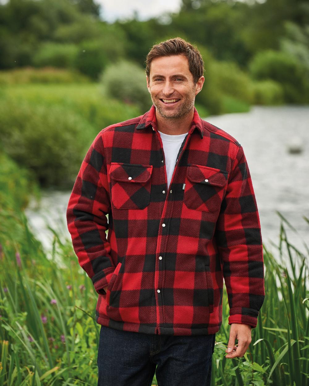Red coloured Champion Kinross Padded Fleece Lumberjack Shirt on pond background 