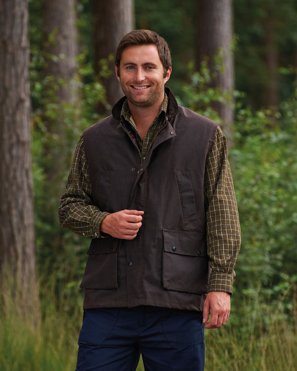 Brown coloured Champion Lanark Waxed Cotton Waistcoat on forest background 