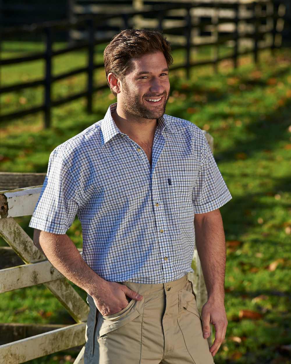 Blue coloured Champion Tattersall Short Sleeved Shirt on backyard background 