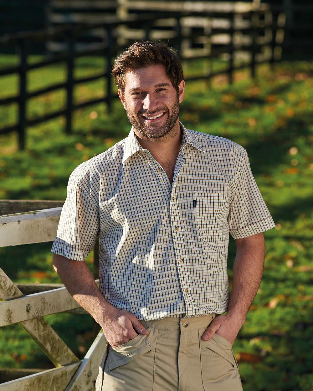 Green coloured Champion Tattersall Short Sleeved Shirt on backyard background 