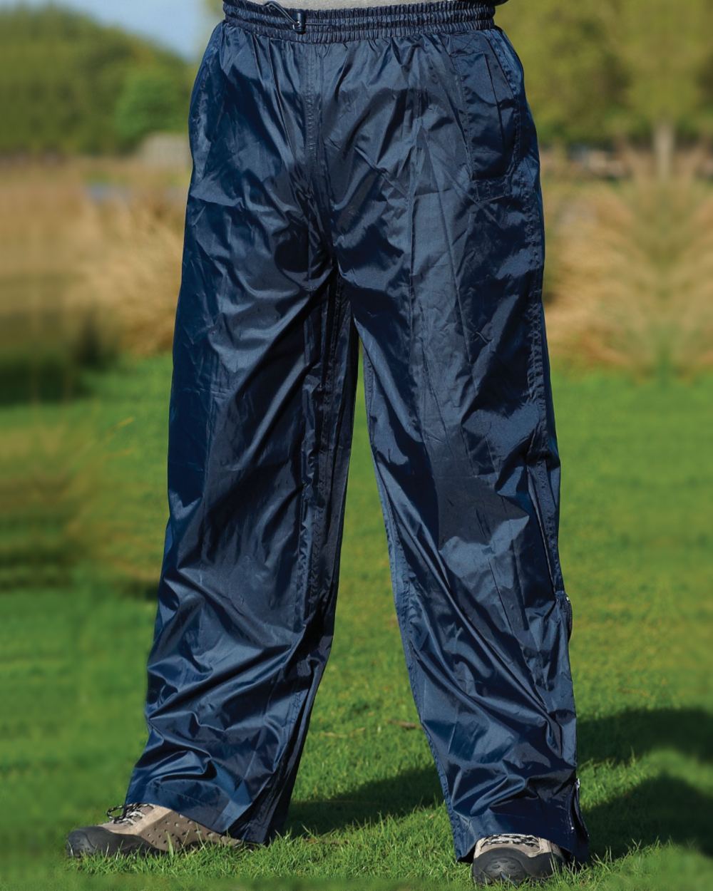 Navy coloured Champion Typhoon Waterproof Over Trousers on lawn background 