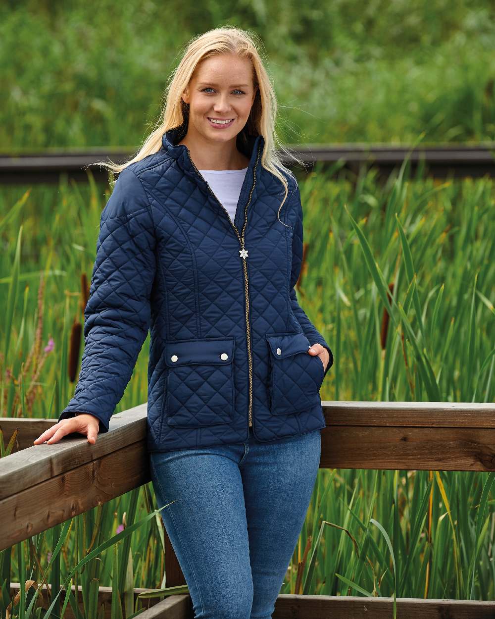 Navy coloured Champion Wisley Quilted Jacket on farm background 