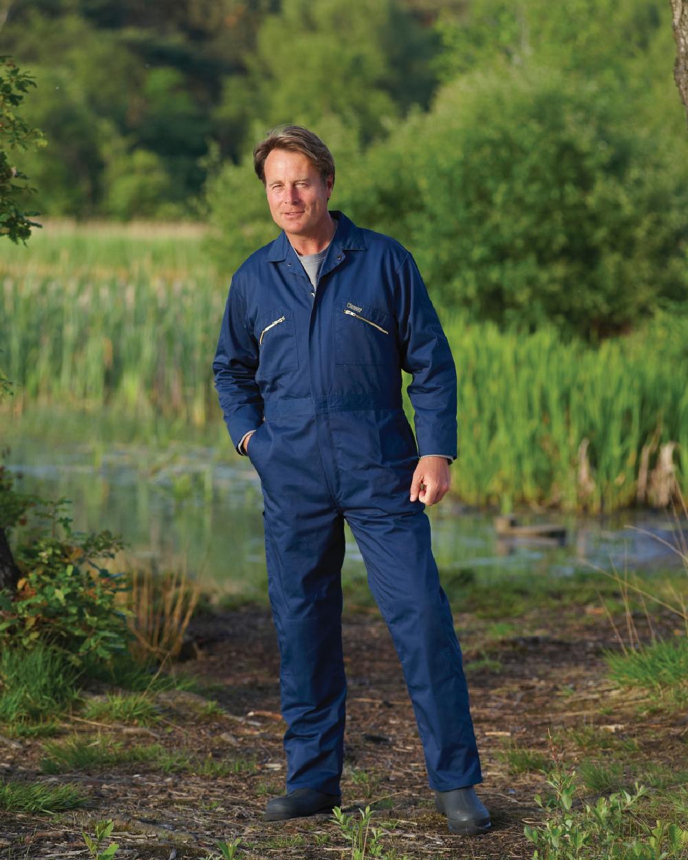 Navy coloured Champion Zipped Poly Cotton Boilersuit Overalls on farm background 