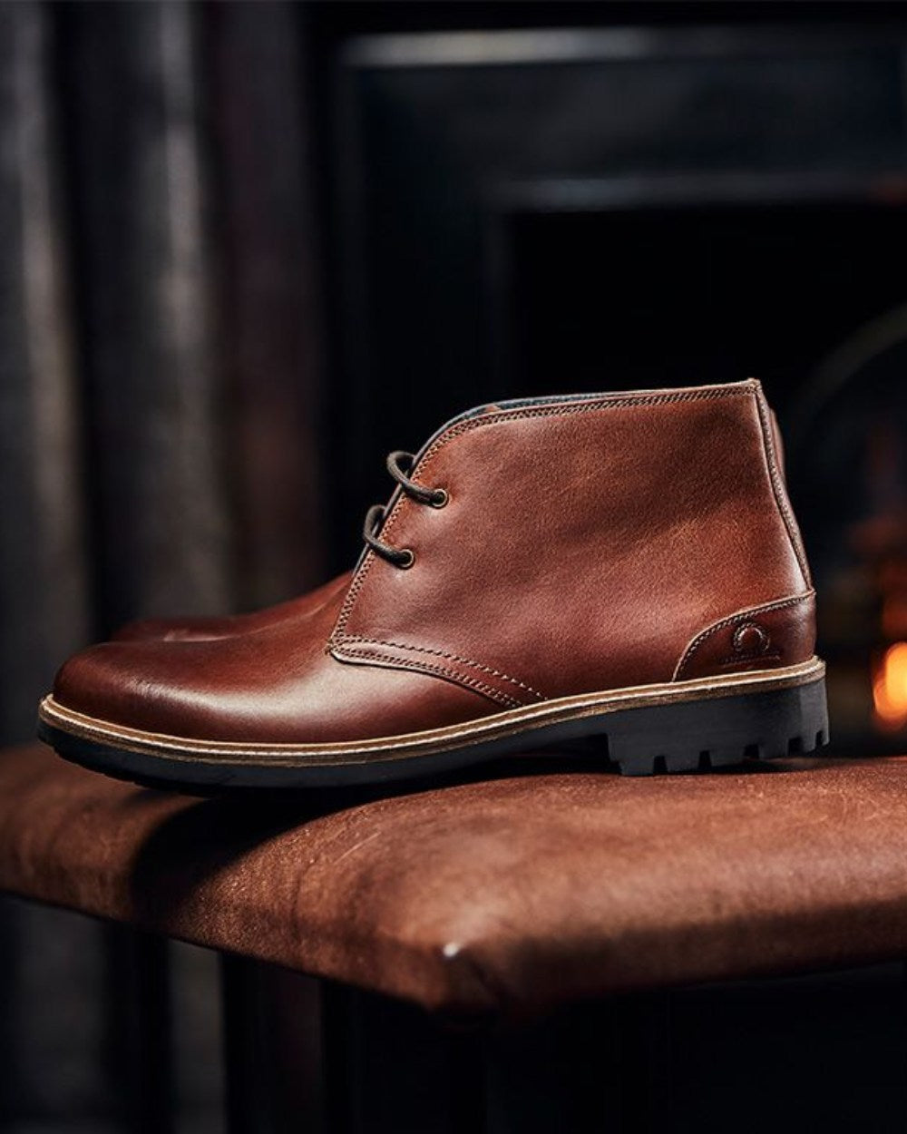 Dark Tan Coloured Chatham Mens Drogo-Premium Leather Chukka Boots on blurry background 