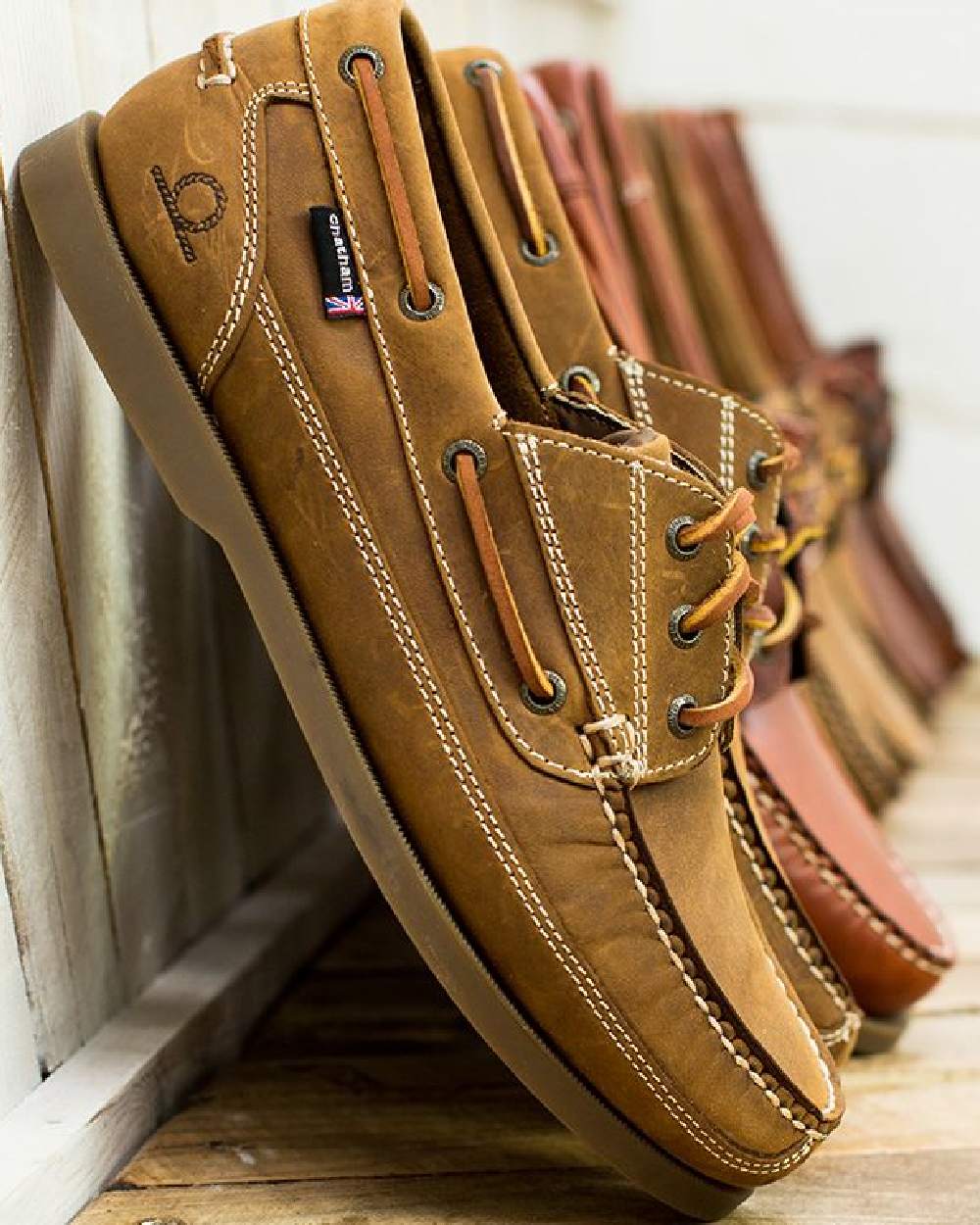 Walnut Coloured Chatham Mens Rockwell II G2 Leather Wide Fit Boat Shoes on wall background 