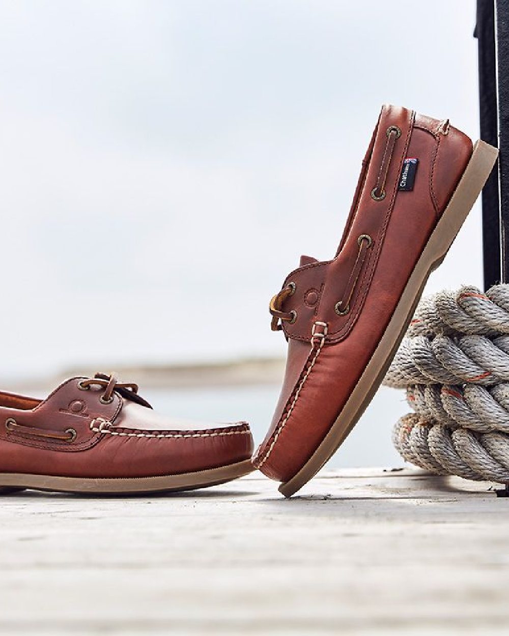 Chestnut Coloured Chatham Mens The Deck II G2 Premium Leather Boat Shoes on blurry background 