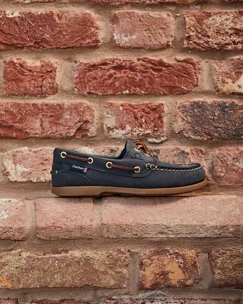 Blue Coloured Chatham Womens Deck II G2 Premium Leather Boat Shoes on wall background 