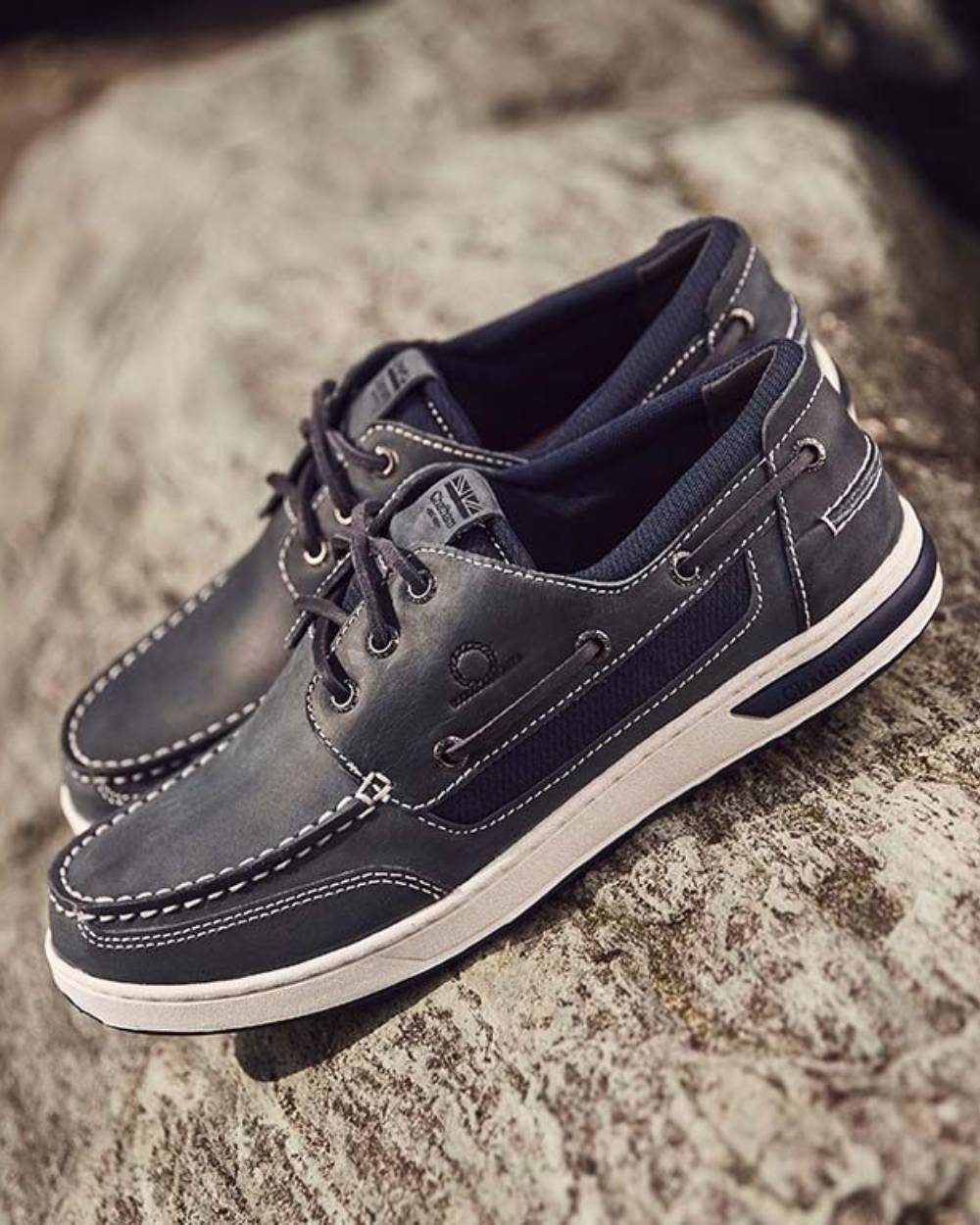 Navy coloured Chatham Mens Buton G2 Premium Leather Deck Shoes on rock background 