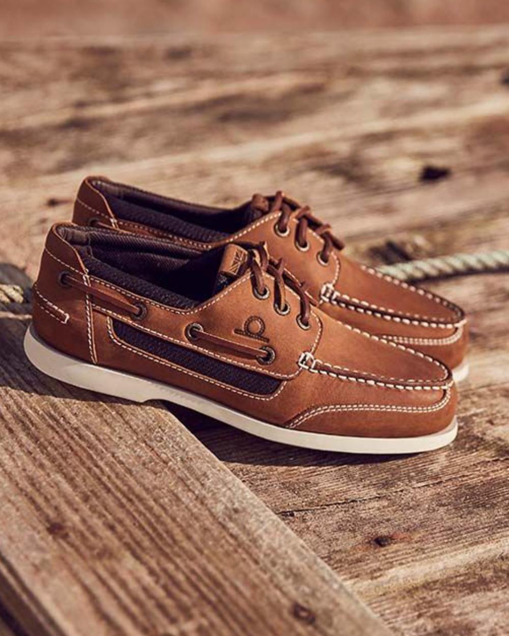 Walnut coloured Chatham Mens Buton G2 Premium Leather Deck Shoes on wooden deck background 