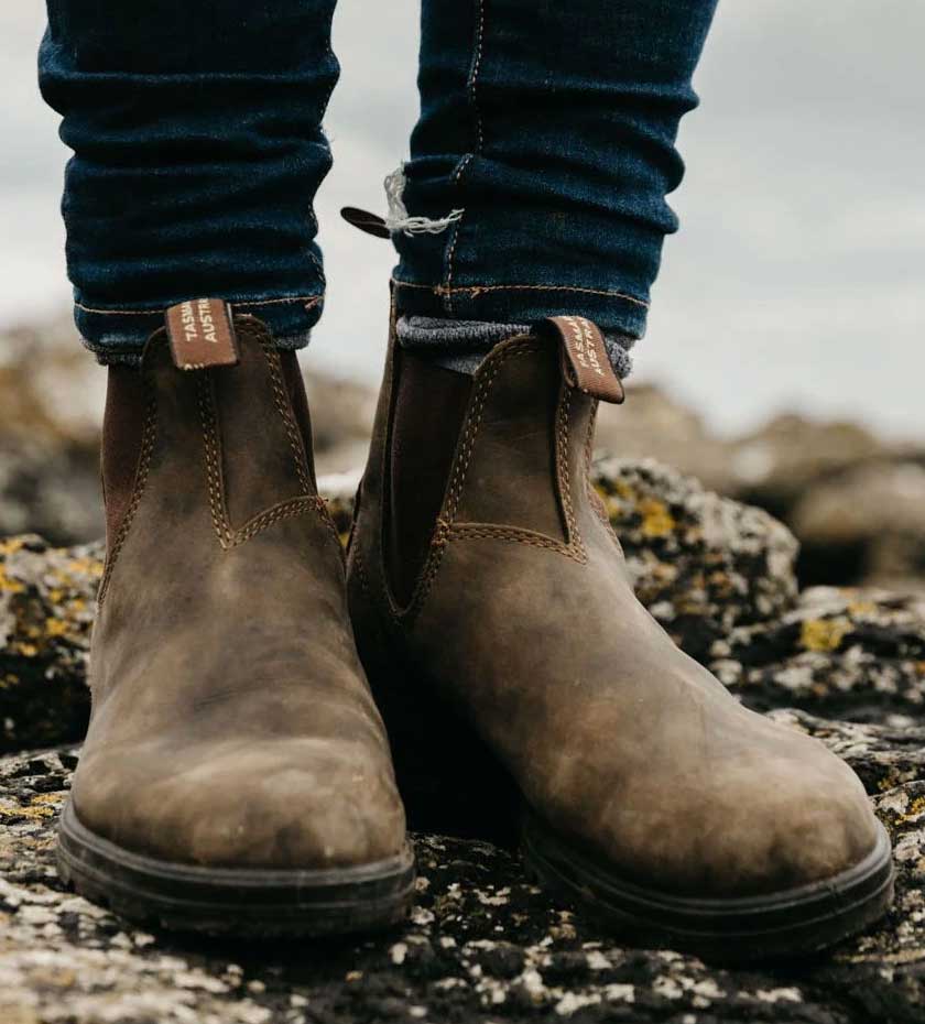 Dealer Boots Chelsea style pull on elasticated boots in leather standing on stoney ground.
