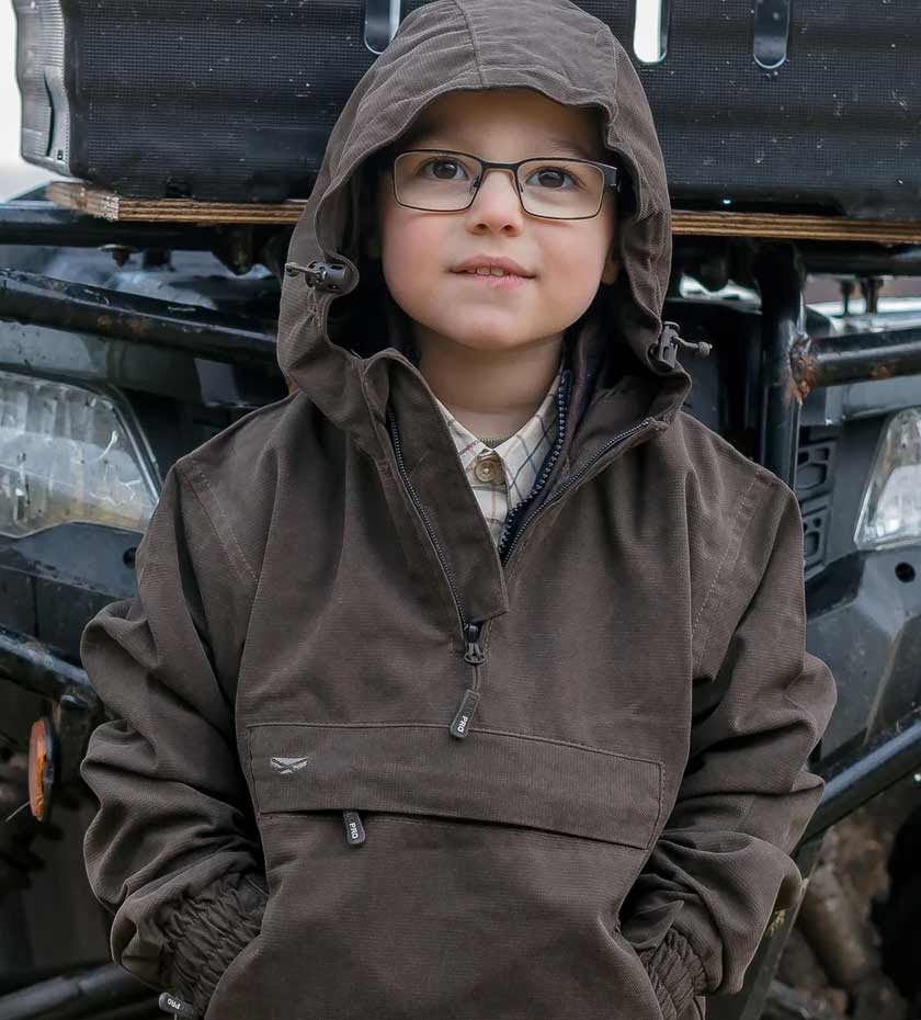 Young boy wears Hoggs struther hooded rain smock in dark green.