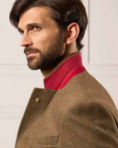 Hawthorn coloured Alan Paine Combrook Mens Tweed Sports Blazer on wall background 