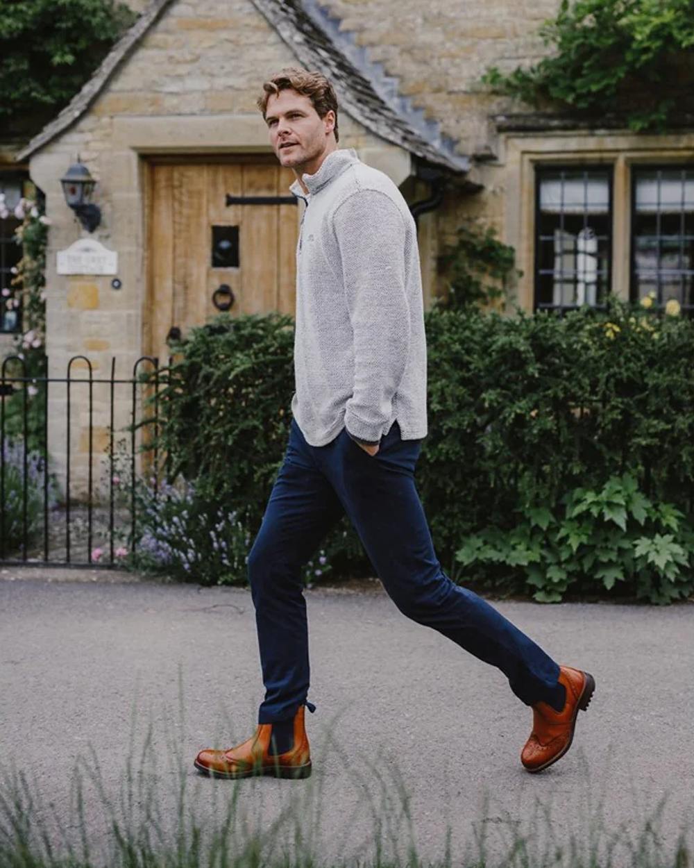 Tan coloured Cotswold Cirencester Chelsea Brogues with house in background 