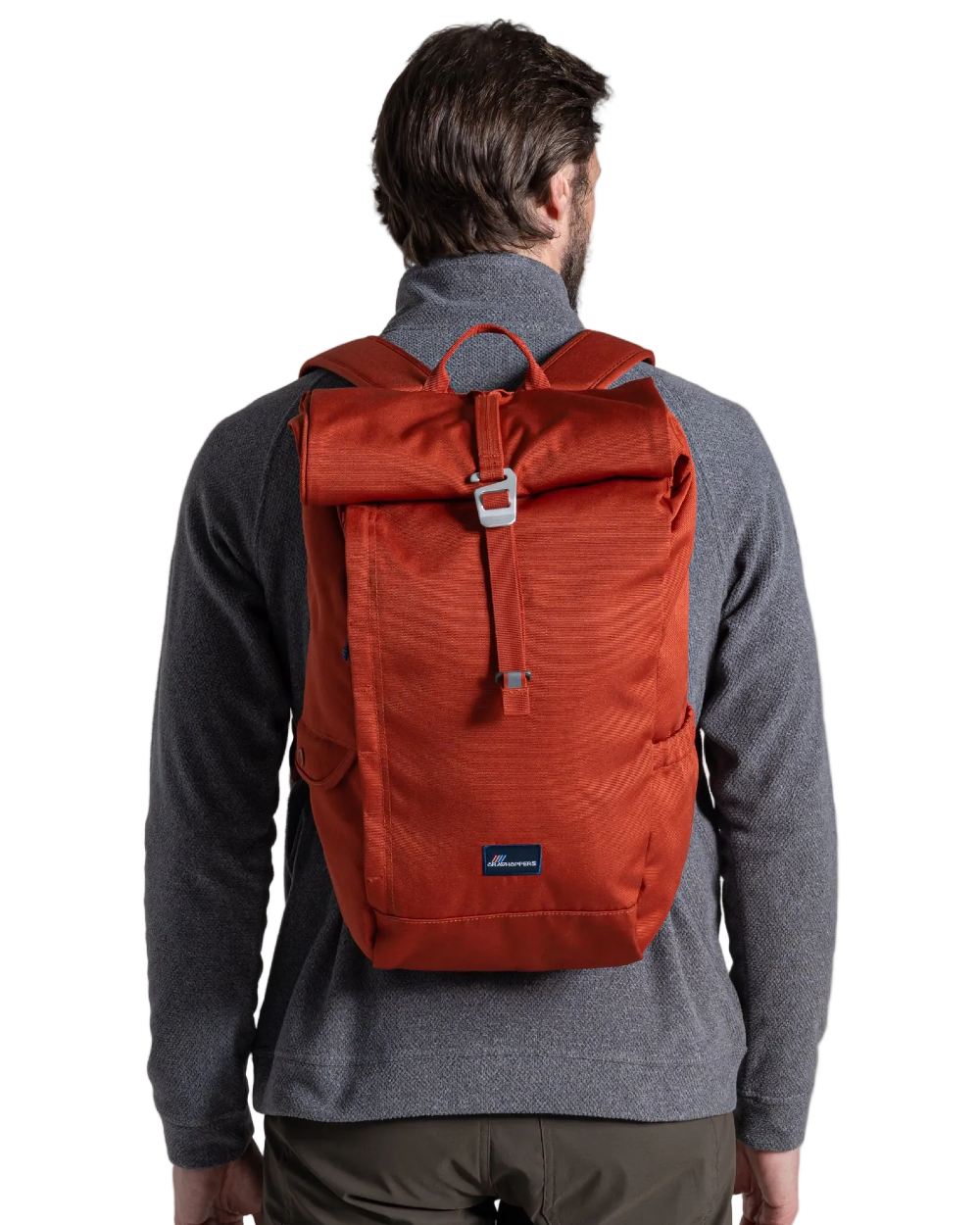 Red Beach coloured Craghoppers 20L Kiwi Classic Rolltop Backpack II on white background 