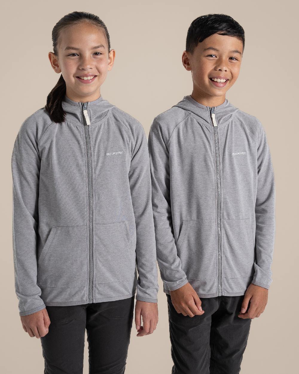Soft Grey Marl Coloured Craghoppers Kids Nosi Life Frey Hooded Jacket on Beige Background 