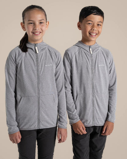 Soft Grey Marl Coloured Craghoppers Kids Nosi Life Frey Hooded Jacket on Beige Background 