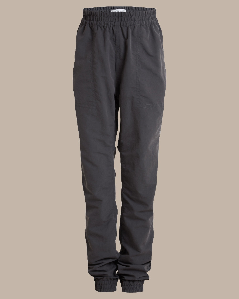 Black Pepper Coloured Craghoppers Kids Nosilife Pinzon Trousers on Beige Background 