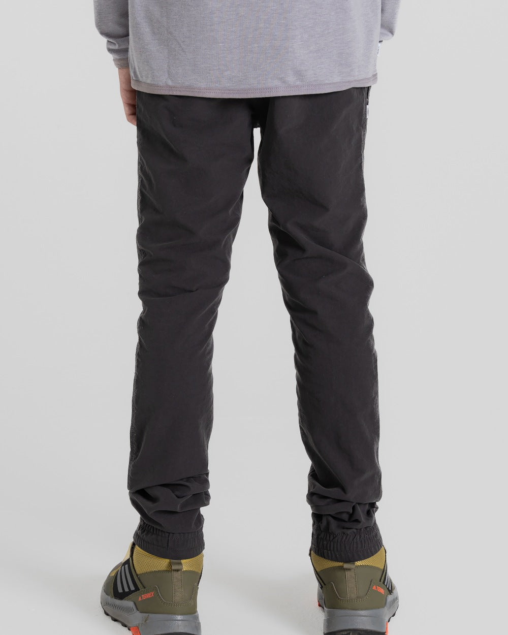 Black Pepper Coloured Craghoppers Kids Nosilife Pinzon Trousers on Beige Background 