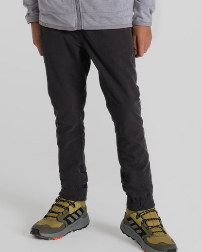 Black Pepper Coloured Craghoppers Kids Nosilife Pinzon Trousers on Beige Background 