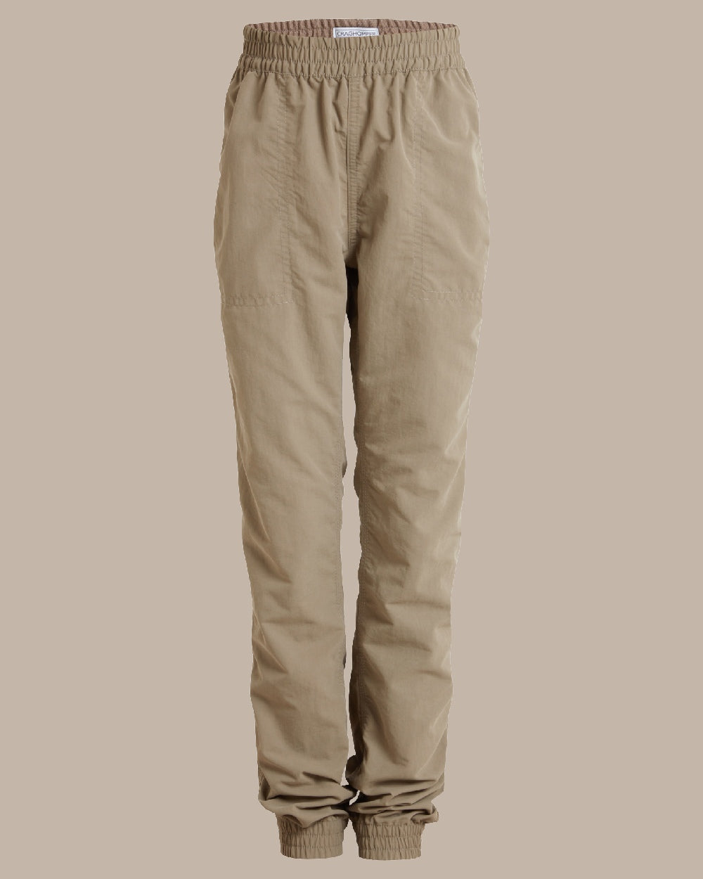 Pebble Coloured Craghoppers Kids Nosilife Pinzon Trousers on Beige Background 