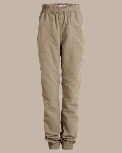 Pebble Coloured Craghoppers Kids Nosilife Pinzon Trousers on Beige Background 