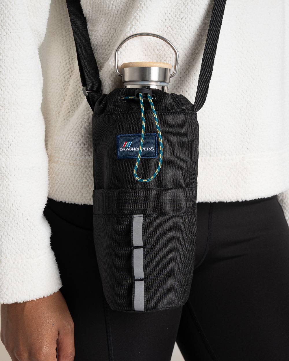Black Coloured Craghoppers kiwi Bottle Bag II On Beige Background 