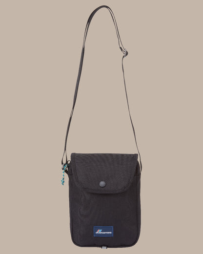 Black Coloured Craghoppers Kiwi Crossbody II on Beige Background 